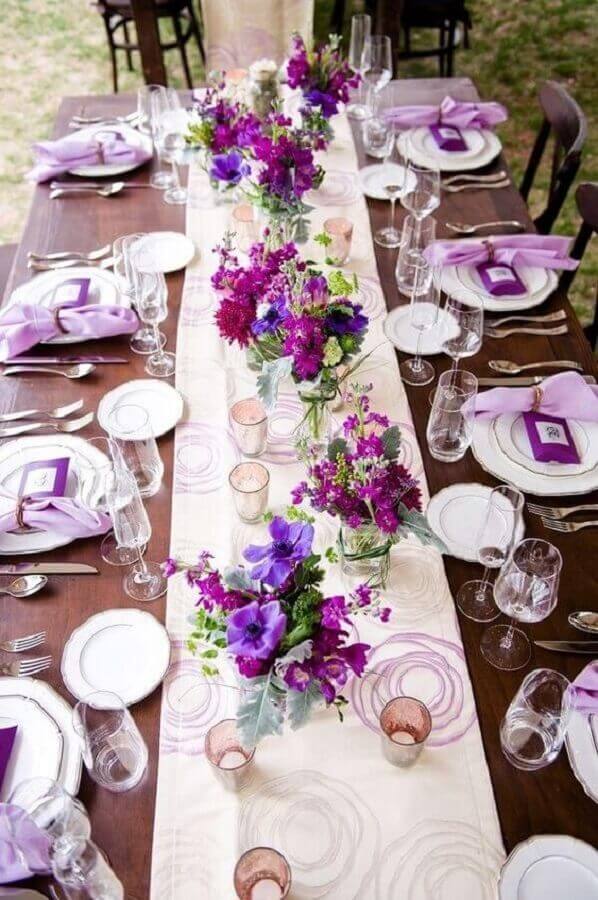 wedding colors decorated with simple purple flower arrangement Photo Save the Bride