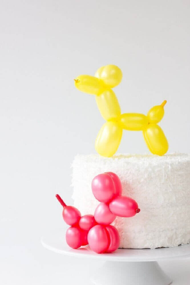 cake decorated with dog-shaped bladder stick Photo Brit + Co